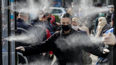 People are disinfected before entering a market, as Albanian authorities take measures to stop the spread of the coronavirus disease (COVID-19), in Tirana, Albania. REUTERS