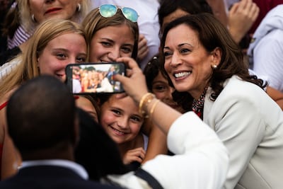 US Vice President Kamala Harris takes photos with those attending a Fourth of July celebration at the White House in Washington. EPA