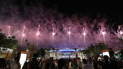 Visitors watch the fireworks display over Al Wasl Avenue at Expo 2020 Dubai.