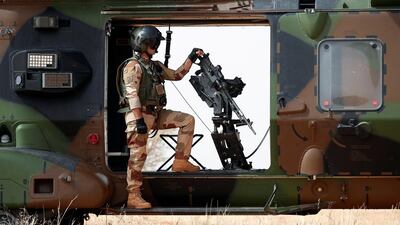 A French soldier stands by a mounted machine gun as he surveys the area during the regional anti-insurgent Operation Barkhane in Inaloglog, Mali. Benoit Tessier / Reuters