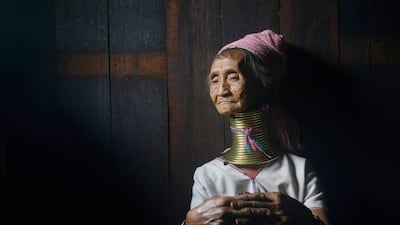 Monu,76, a Kayan tribeswoman sits in her home wearing a stack of bronze neck coils – the statuesque sign of beauty of her Kayan tribe, at Panpet village located in Demoso township in Kayah state, central Myanmar. Phyo Hein Kyaw/AFP