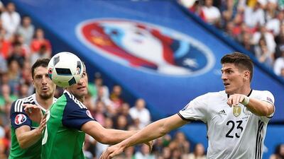 Germany's forward Mario Gomez (R) and Northern Ireland's defender Craig Cathcart and Northern Ireland's defender Aaron Hughes vie for the ball during the Euro 2016 group C football match between Northern Ireland and Germany at the Parc des Princes stadium in Paris on June 21, 2016. / AFP / LIONEL BONAVENTURE