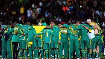 The South Africa coach Joel Santana, centre, with his players after the 1-0 loss to Brazil.