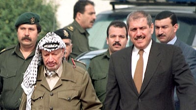Yasser Arafat, then-president of the Palestinian Authority, walks hand-in-hand with Jordan’s then-prime minister Fayez Tarawneh, in Gaza city.. AFP