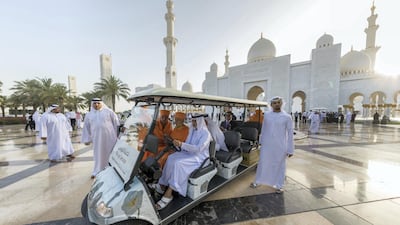 Sheikh Nahyan drives Mahant Swami Maharaj in a golf car to view the Martyrs' Memorial.