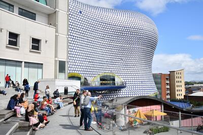 People sit outside the Bullring shopping centre in Birmingham. The average rental yield in the city is 6.56 per cent in 2022, far higher than many London landlords achieved. AFP