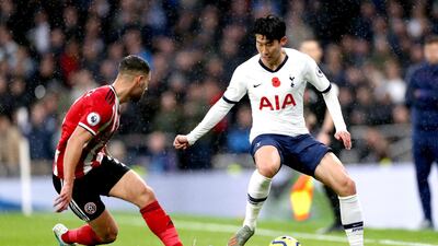 Sheffield United's George Baldock and Tottenham Hotspur's Son Heung-min vie for the ball at Tottenham Hotspur Stadium. PA