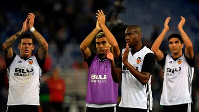 From left: Valencia's Santiago Mina Lorenzo, Andreas Pereira, Geoffrey Kondogbia and Carlos Soler applaud supporters at the end of the game against Espanyol at the RCDE Stadium. Valencia won the match 2-0. Lluis Gene / AFP