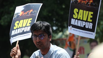 A demonstrator in New Delhi takes part in a protest against the violence in Manipur state on Thursday. EPA