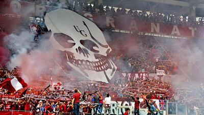 Torino supporters cheer and light flares prior to a Serie A match against Juventus, at the Turin Olympic stadium, Italy, Sunday, April 26, 2015. Fireworks have exploded inside the stadium during the Torino-Juventus derby, injuring multiple fans. Before the match, Torino fans attacked the bus carrying Juve's players to the stadium, breaking a window. (Andrea Di Marco/Ansa via AP)