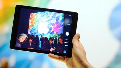 An Apple employee demonstrates the camera on an Apple iPad Air. Apple is said to be manufacturing new iPads. Dominic Lipinski / PA Wire