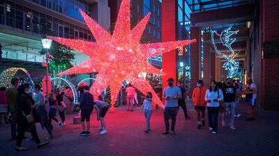 People enjoy Christmas decorations in Melrose Arch, Johannesburg, on December 21. AFP