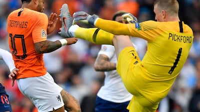 Pickford fights for the ball with Depay. AP Photo