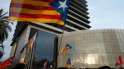 Pro-independence demonstrators waving independence flags, gather outside the German consulate to protest the detention of deposed leader of Catalonia's pro-independence party Carles Puigdemont in Barcelona, Spain, on March 25, 2018. Manu Fernandez / AP Photo