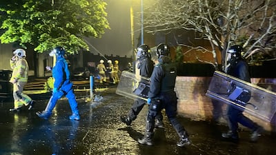 Firefighters and riot police on the streets. PA
