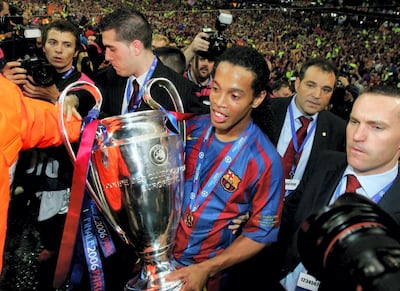 PARIS - MAY 17: Ronaldinho of Barcelona carries the trophy in celebration after his team wins the UEFA Champions League Final between Arsenal and Barcelona at the Stade de France on May 17, 2006 in Paris, France. (Photo by Alex Livesey/Getty Images)