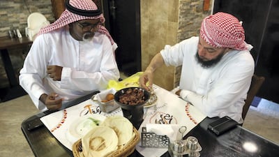Two gentlemen enjoy their dinner at Al Mufraka - one of Abu Dhabi's Sudanese restaurants. All photos by Chris Whiteoak / The National