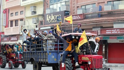Indian farmers and youngsters shout slogans riding on tractor trolleys in a closed market during a nation-wide strike call given by various farmers' organizations as a protest against the new agricultural laws introduced by the government and to demand a roll-back of those laws, in Amritsar, India. Farmers all over India have called for a one day nationwide strike,to demand the rollback in three Agri-bills of the Central Government and new Electricity Bill 2020, stating that these are against the interest of the farmers. Thousands of farmers gathered and tried to cross the sealed New Delhi border points to hold protests against the Government's new agricultural laws. Farmers have been stopped by the police at the various points outside Delhi border which are connected with neighbouring states of Haryana and Uttar Pradesh. EPA