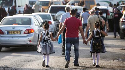 Palestinians of all ages head towards the chaotic Qalandia checkpoint to pray in Jerusalem. The Friday mornings during Ramadan is the most crowded foot traffic time at Qalandia, as tens of thousands of Palestinians from all around the West Bank cross through to pray in Jerusalem. Photo by Heidi Levine for The National