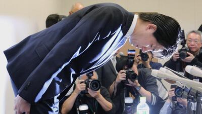 Japan's Liberal Democratic Party MP Kensuke Miyazaki bows after admitting to an affair with a bikini model while his wife was pregnant. Mr Miyazaki had been a champion of paternity leave. Jiji Press / AFP Photo