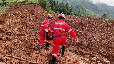 This photo taken on July 25, 2019 shows rescuers working at the site of a landslide in Liupanshui in China's southwestern Guizhou province. AFP