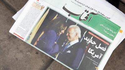 A copy of Iranian daily Aftab with a picture of Joe Biden and Kamala Harris and a headline 'New chapter of US' is displayed in front of a kiosk in Tehran. EPA