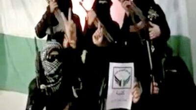 A video showing half a dozen women concealed by black headscarves and sunglasses and holding assault rifles was posted on YouTube to mark the formation of the brigade. (Screen grab / Youtube)