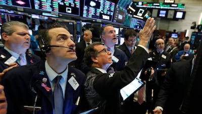 Traders gather at a post on the floor of the New York Stock Exchange. AP