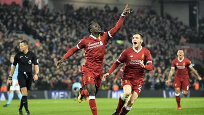 Sadio Mane celebrates with teammate Andy Robertson after scoring the third Liverpool goal against Manchester City at Anfield. Shaun Botterill / Getty Images