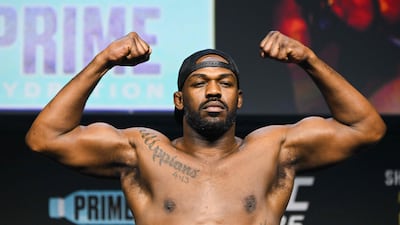 Jon Jones poses on the scale. AFP