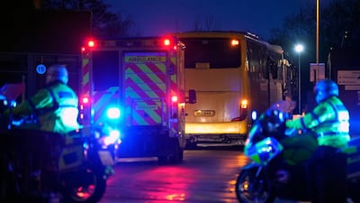 An ambulance and police are seen as coaches containing British Diamond Princess evacuees arrive at Arrowe Park Hospital in Wirral, United Kingdom. Getty