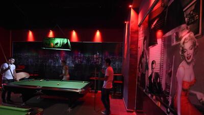 Young men and women - many of them without the veil - play billiards at the entertainment area of the Bab Ezzouar mall. AFP Photo / Farouk Batiche