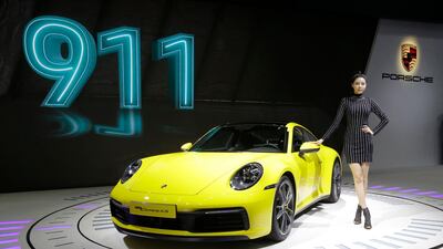 A model poses with a Porsche 911 Carrera 4S. Ahn Young-Joon / AP