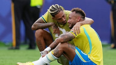 Neymar is consoled by Raphinha after Brazil were eliminated from the World Cup. Reuters