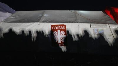 The shadows of migrants fall on the tent of the Catholic aid organistaion Caritas at the Hungarian border with Serbia. Migrants are rushing to the border due to fears and rumours that the borders will soon close.