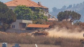 An Israeli tank in Zawtar Al Sharkiyeh, seen from nearby Zawtar Al Gharbiyeh, which Lebanese soldiers entered last week after the Israeli military's withdrawal. Reuters