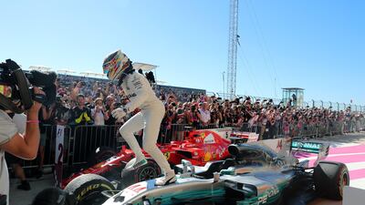 Mercedes driver Lewis Hamilton leaps out of his car to celebrate his win as closes in on his fourth world title. Srdjan Suki / EPA