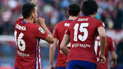 Atletico Madrid’s Argentinian midfielder Angel Correa (L) celebrates after scoring during the La Liga match Atletico Madrid v Granada CF at the Vicente Calderon stadium in Madrid on April 17, 2016. AFP / GERARD JULIEN