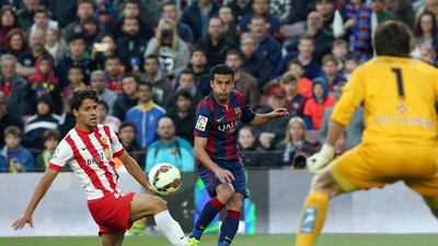 Barcelona's Pedro curls a pass on Wednesday in Barca's La Liga win over Almeria at the Camp Nou. Toni Albir / EPA / April 8, 2015