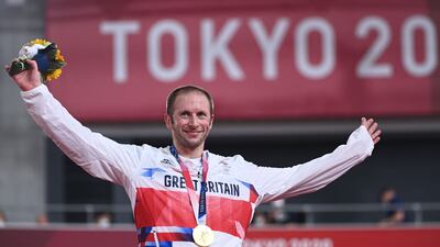Jason Kenny poses with his medal on the podium after the men's track cycling keirin final.