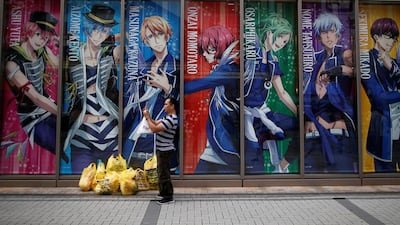 A tourist from abroad takes a photo at Akihabara shopping and amusement district in Tokyo, Japan. Issei Kato / Reuters