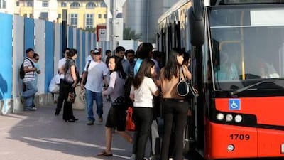 Commuters waiting for the bus at the bus stop without shelter near the Flora Park Hotel in Deira.