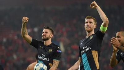 Olivier Giroud and Per Mertesacker of Arsenal celebrate after reaching the Champions League last 16 earlier this month. Michael Regan / Getty Images / December 9, 2015