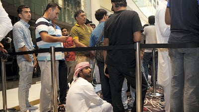 People wait for the doors to open at the Apple Store at Dubai Mall. Anna Nielsen for The National