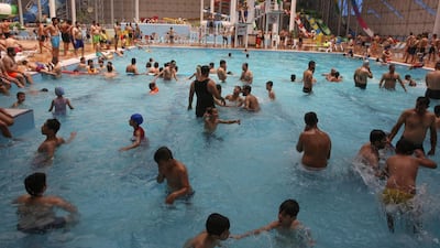 Iraqis gather at an indoor water park during a heatwave.