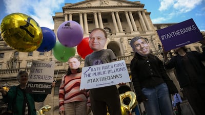Protesters wearing masks of Britain's Prime Minister Rishi Sunak and Bank of England Governor Andrew Bailey during a protest outside the Bank Of England in the City of London. AFP