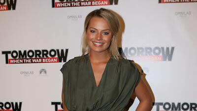 Margot Robbie, in a khaki jumpsuit, arrives at the 'Tomorrow When the War Began' premiere on August 11, 2010 in Melbourne, Australia. Getty Images