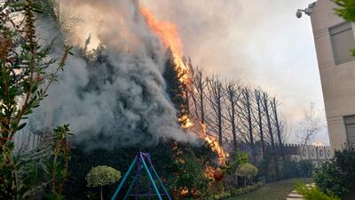 A fire is seen near a house in Mechref. EPA