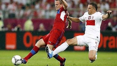 Poland's Dariusz Dudka, right, tackles Czech Republic's David Limbersky during their Group A Euro 2012 match, won by the Czechs 1-0 on Saturday.