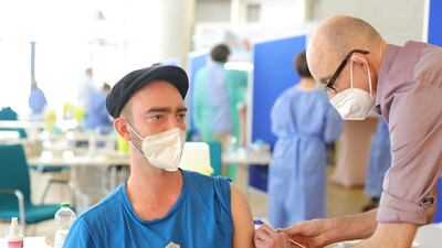 A local resident receives an AstraZeneca vaccine inside the city's main mosque, which has temporarily become a mass vaccination centre in Cologne, Germany. Getty Images